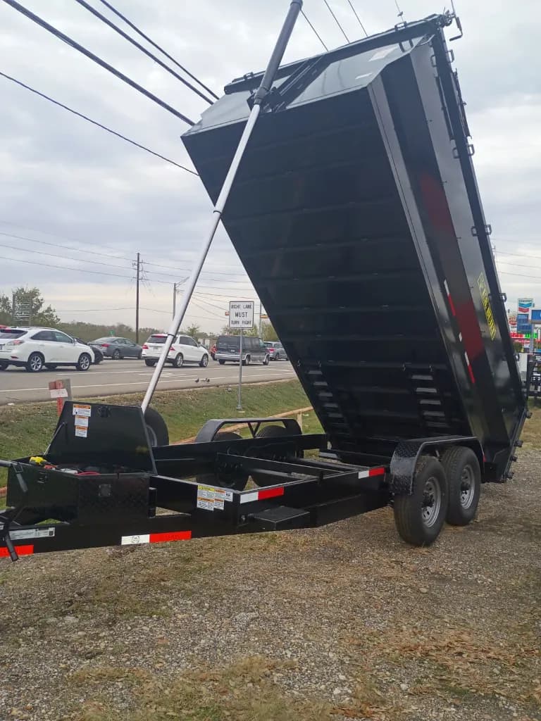 16 foot dump trailer in raised dumping position to show the hydraulic lift and unloading angle.