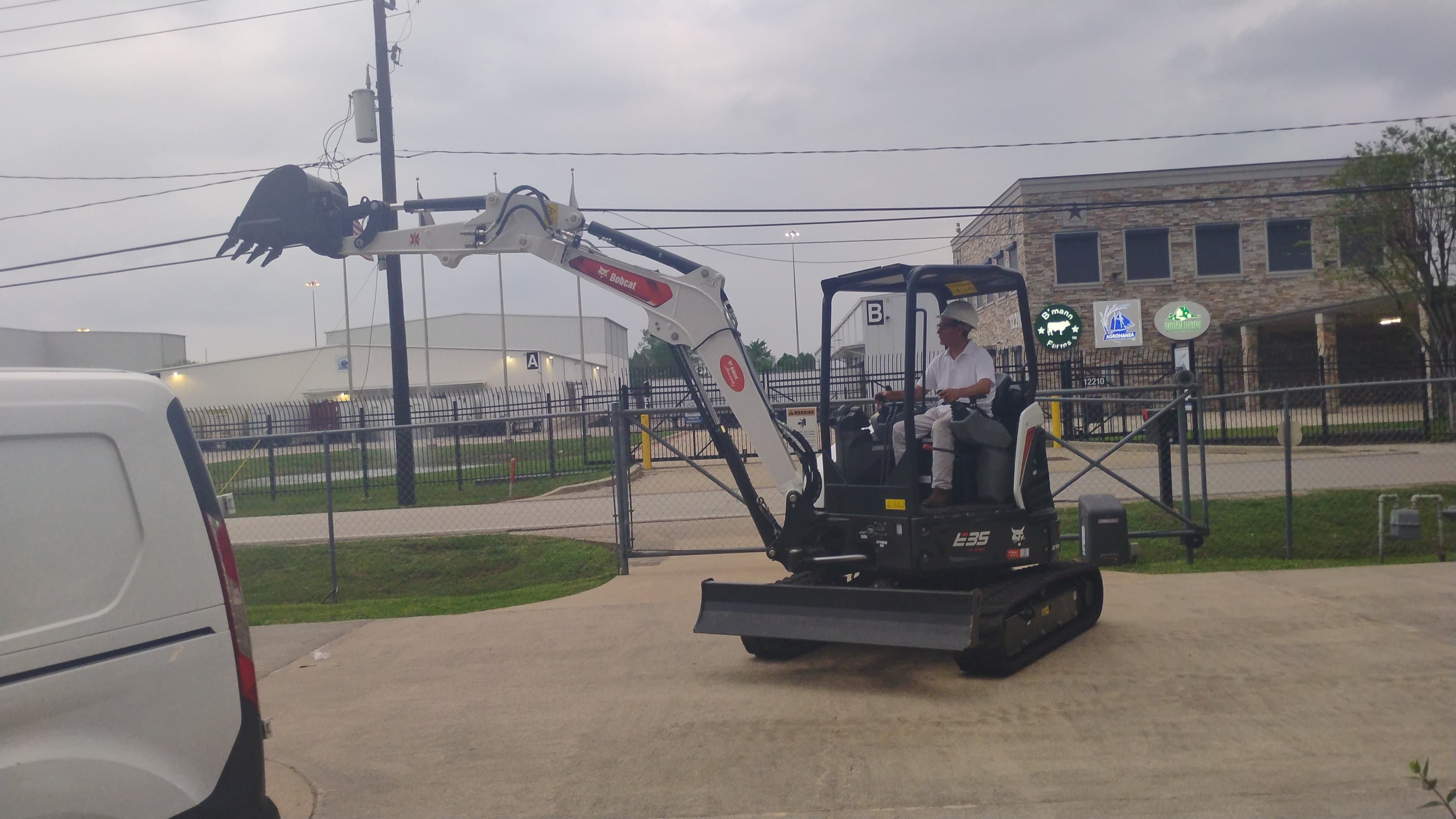 Bobcat E35 compact excavator in Houston with the boom extended outward to demonstrate reach.