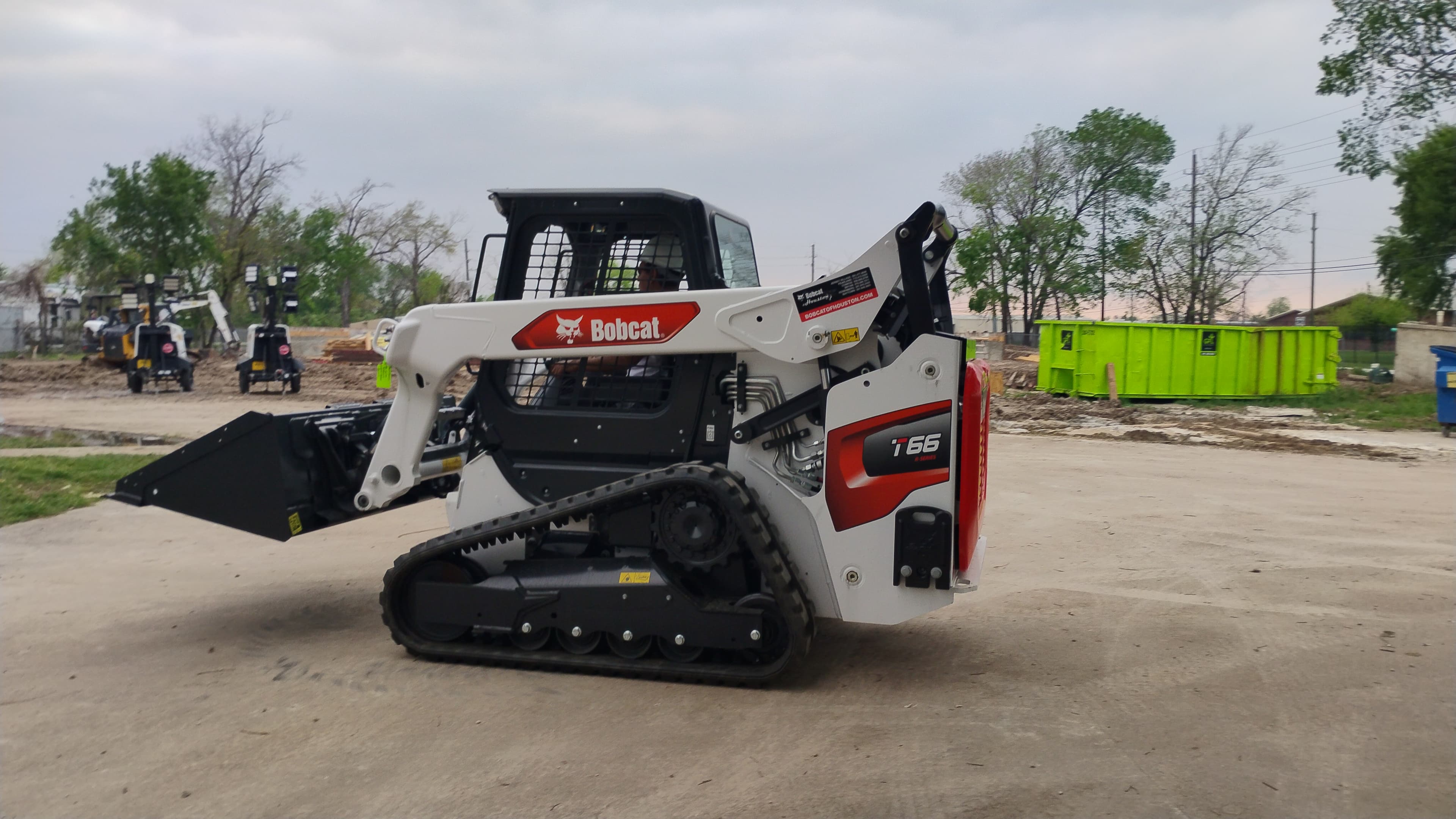 Bobcat T66 compact track loader in Houston from the rear side with the bucket low and the track profile visible.