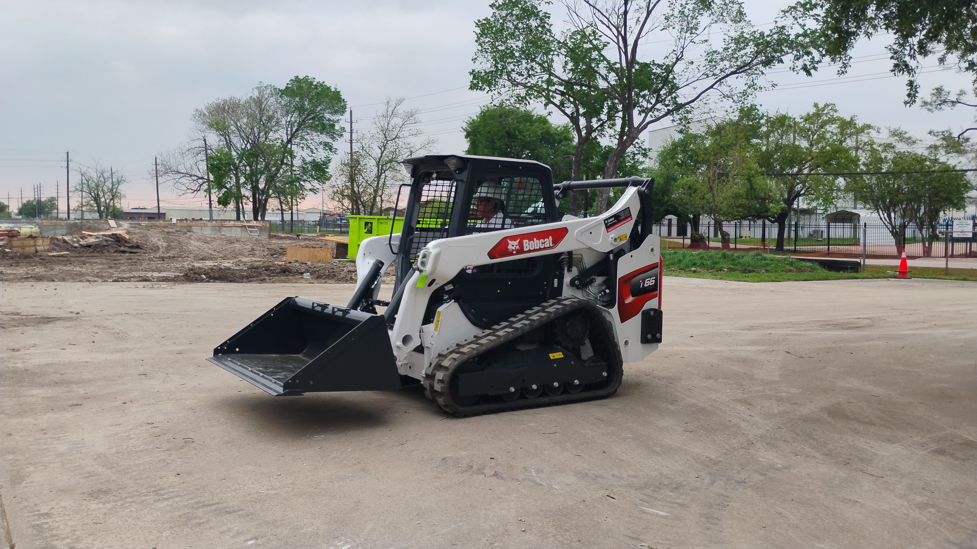 Side view of the Bobcat T66 compact track loader in Houston with the bucket low and ready for work.