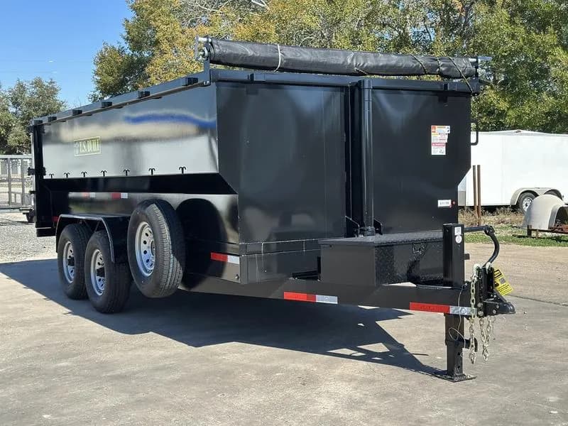 Black 16 foot dump trailer parked in Houston and ready for debris hauling, construction cleanup, and material transport.